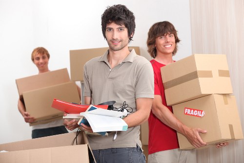 Removals team loading furniture for a Westealing house move