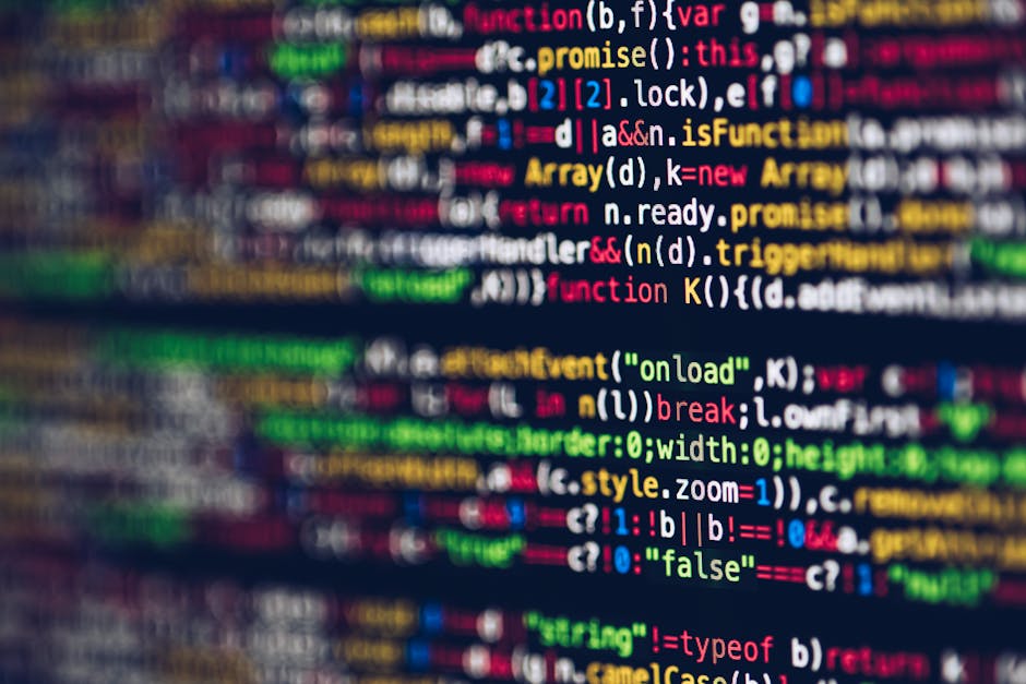 Photograph showing a close-up of a computer screen displaying a colorful and blurred code script with various lines of programming language, including keywords, functions, and tags in different colors